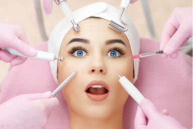 A young woman receives a facial treatment with various skincare tools.